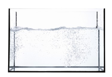 Photo of Glass aquarium with splashing water isolated on white