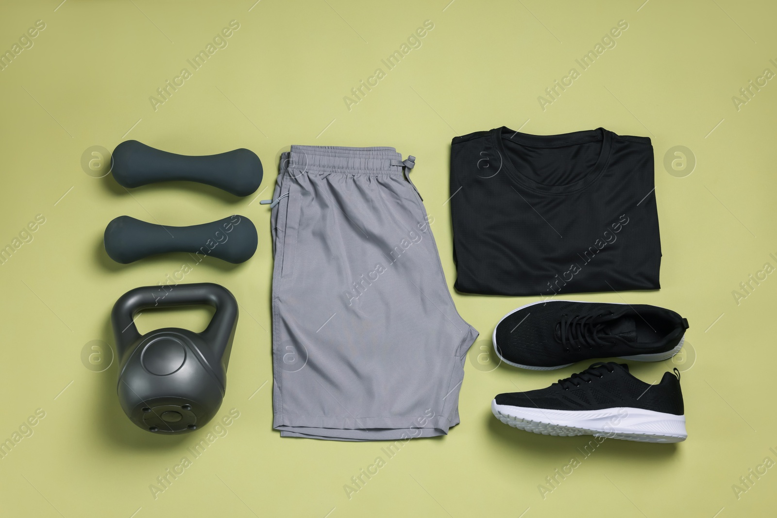 Sportswear, sneakers, dumbbells and kettlebell on pale olive background, flat lay Photo of Sportswear, sneakers, dumbbells and kettlebell on pale olive background, flat lay