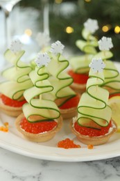 Photo of Tasty canapes and Christmas decor on white marble table, closeup