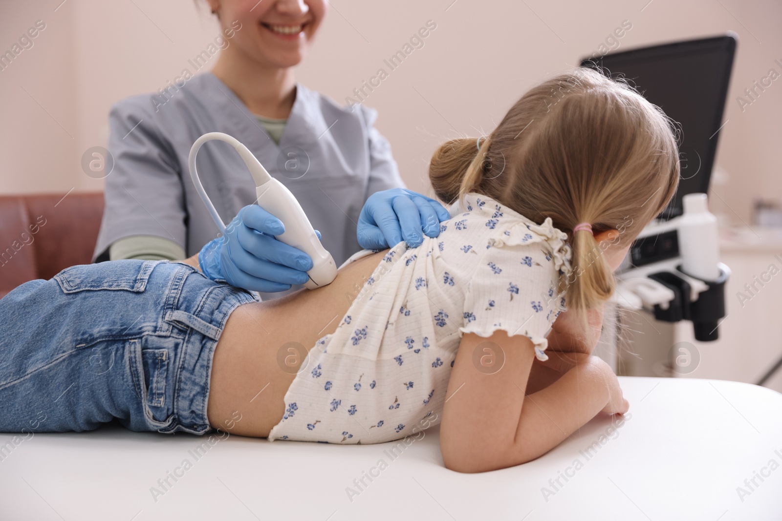 Sonographer conducting little girl's renal ultrasound examination in clinic, closeup Photo of Sonographer conducting little girl's renal ultrasound examination in clinic, closeup