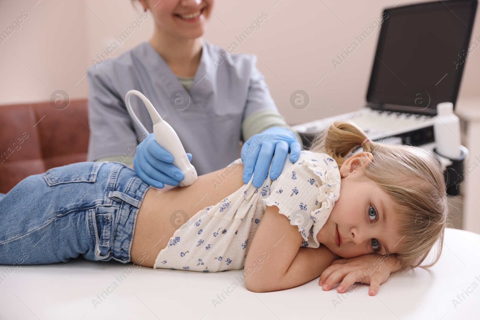 Sonographer conducting little girl's renal ultrasound examination in clinic, closeup Photo of Sonographer conducting little girl's renal ultrasound examination in clinic, closeup