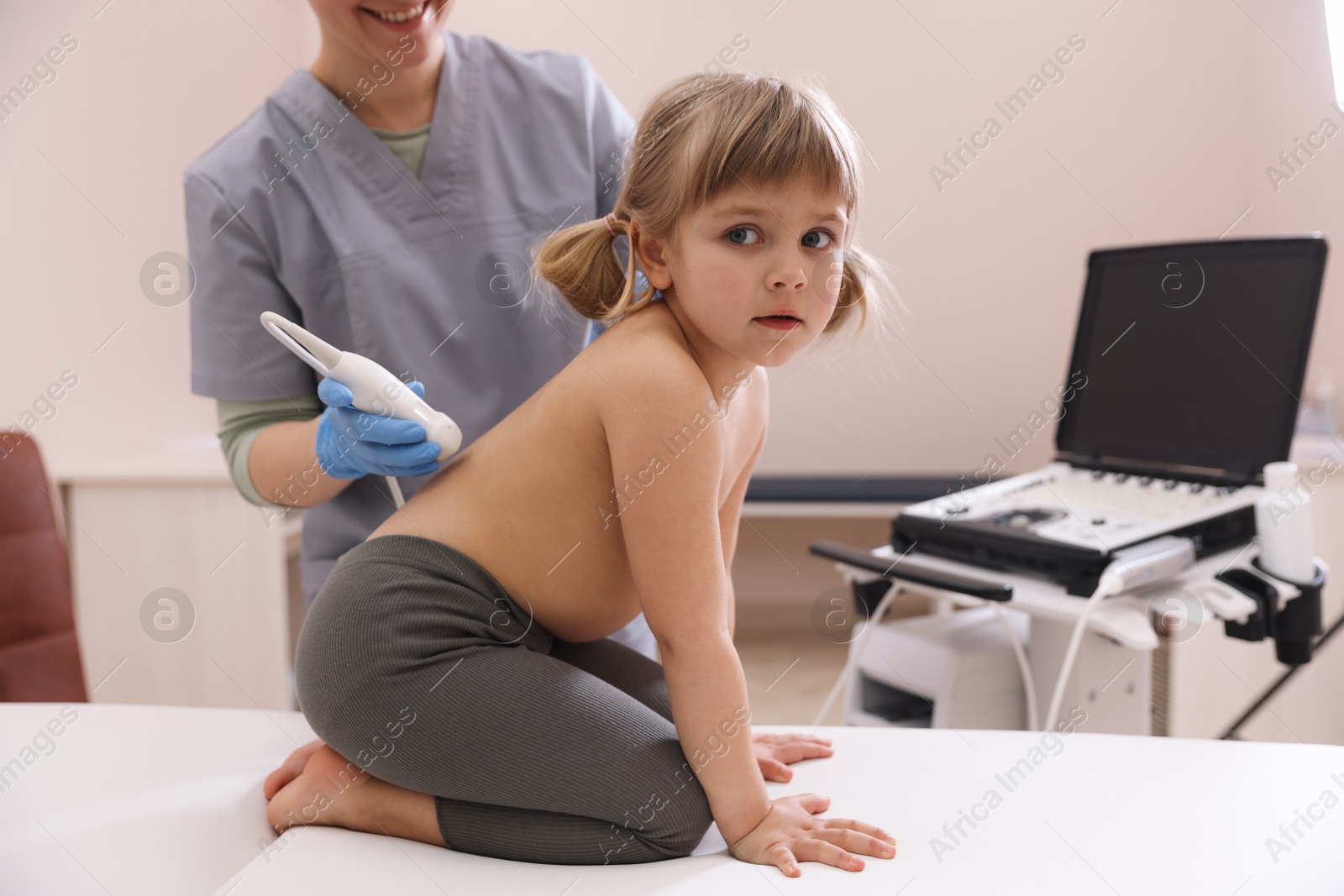 Sonographer conducting little girl's renal ultrasound examination in clinic, closeup Photo of Sonographer conducting little girl's renal ultrasound examination in clinic, closeup