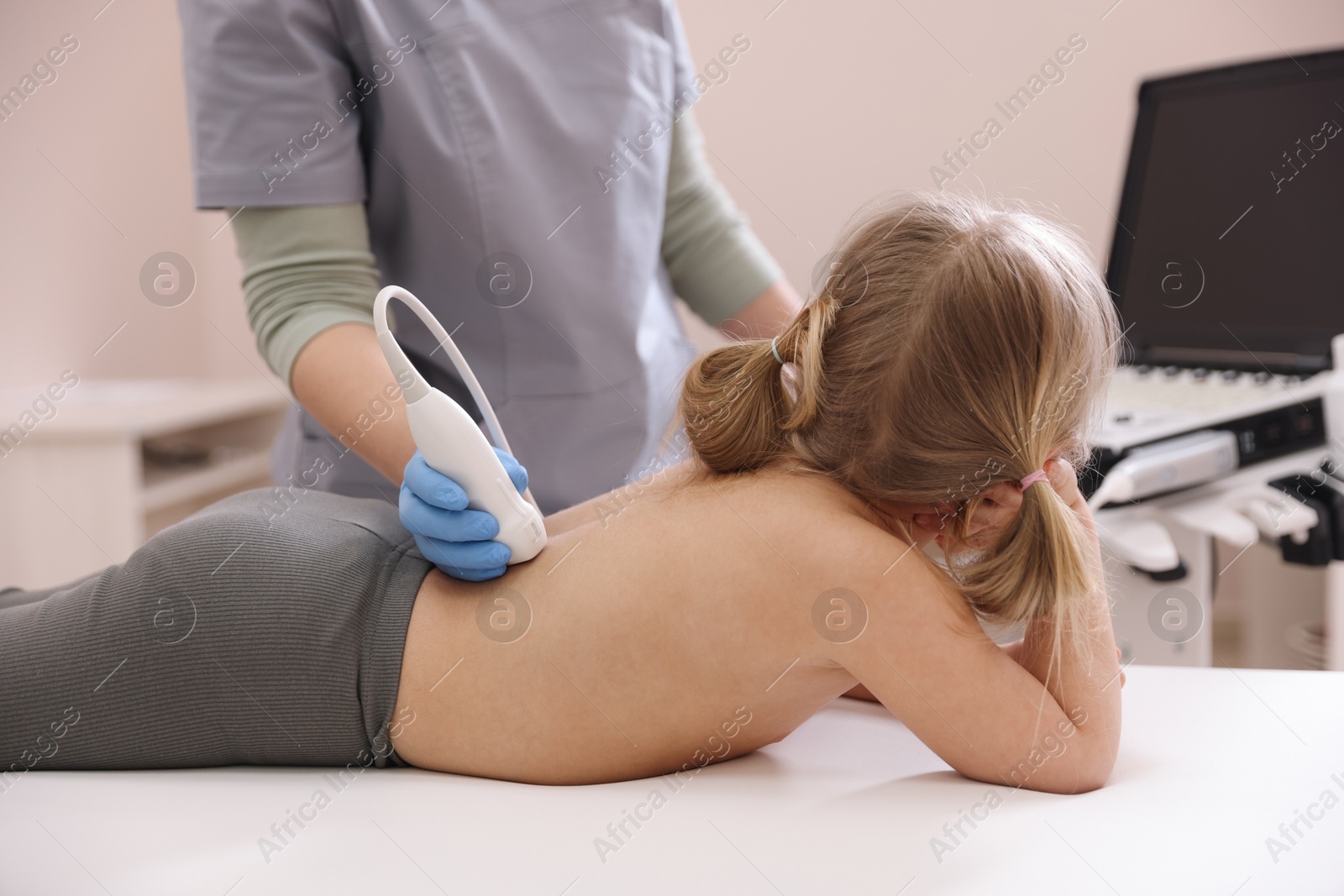 Sonographer conducting little girl's renal ultrasound examination in clinic, closeup Photo of Sonographer conducting little girl's renal ultrasound examination in clinic, closeup
