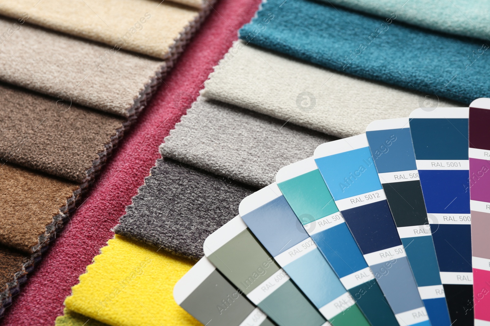 Photo of Samples of colorful fabrics and color palettes, closeup