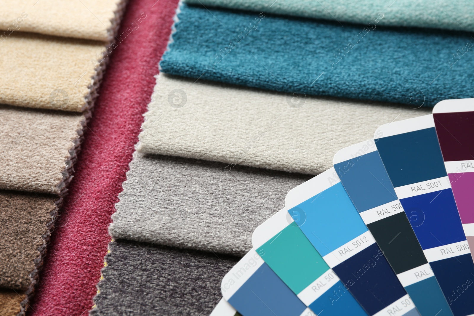 Photo of Samples of colorful fabrics and color palettes, above view