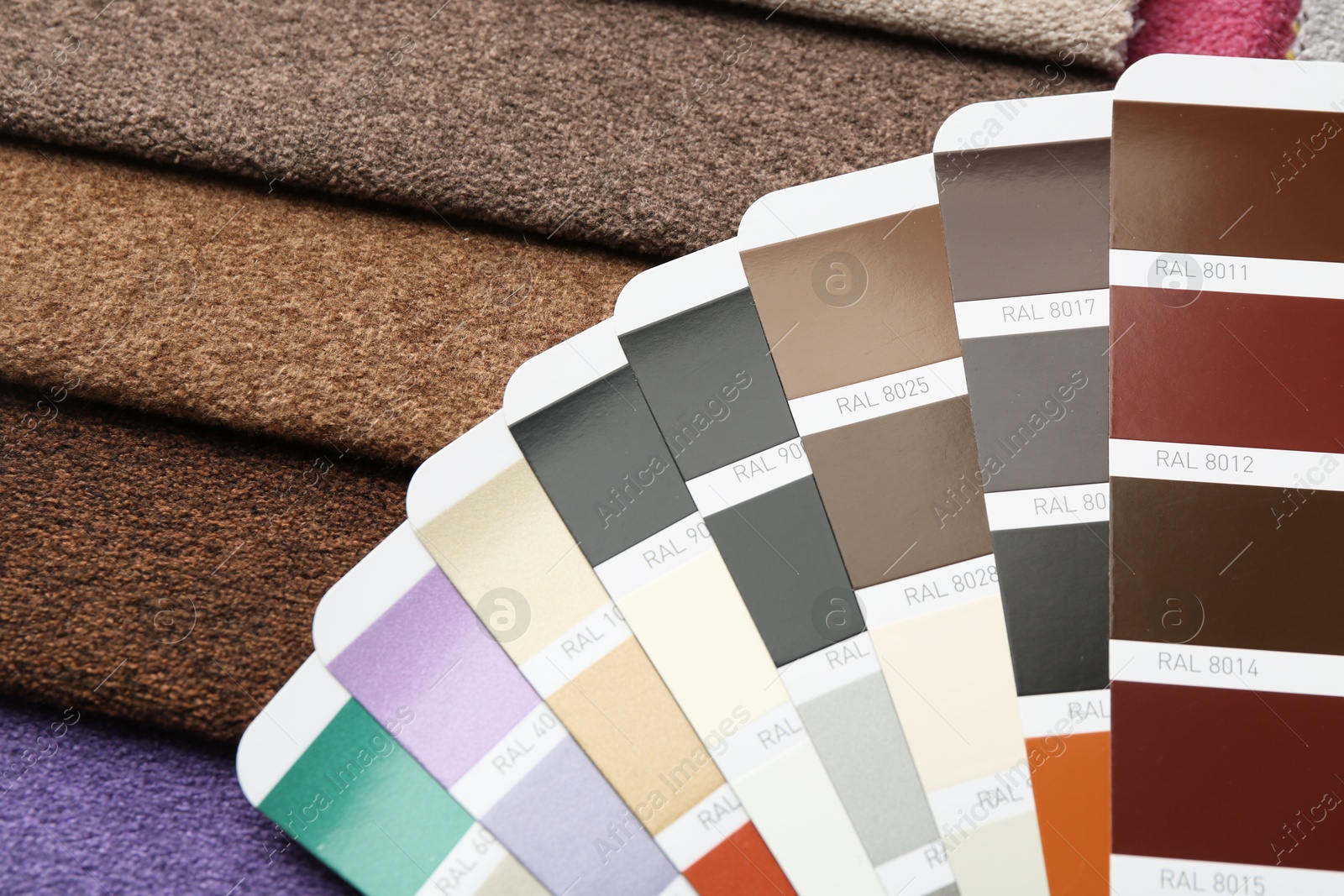 Photo of Samples of colorful fabrics and color palettes, above view