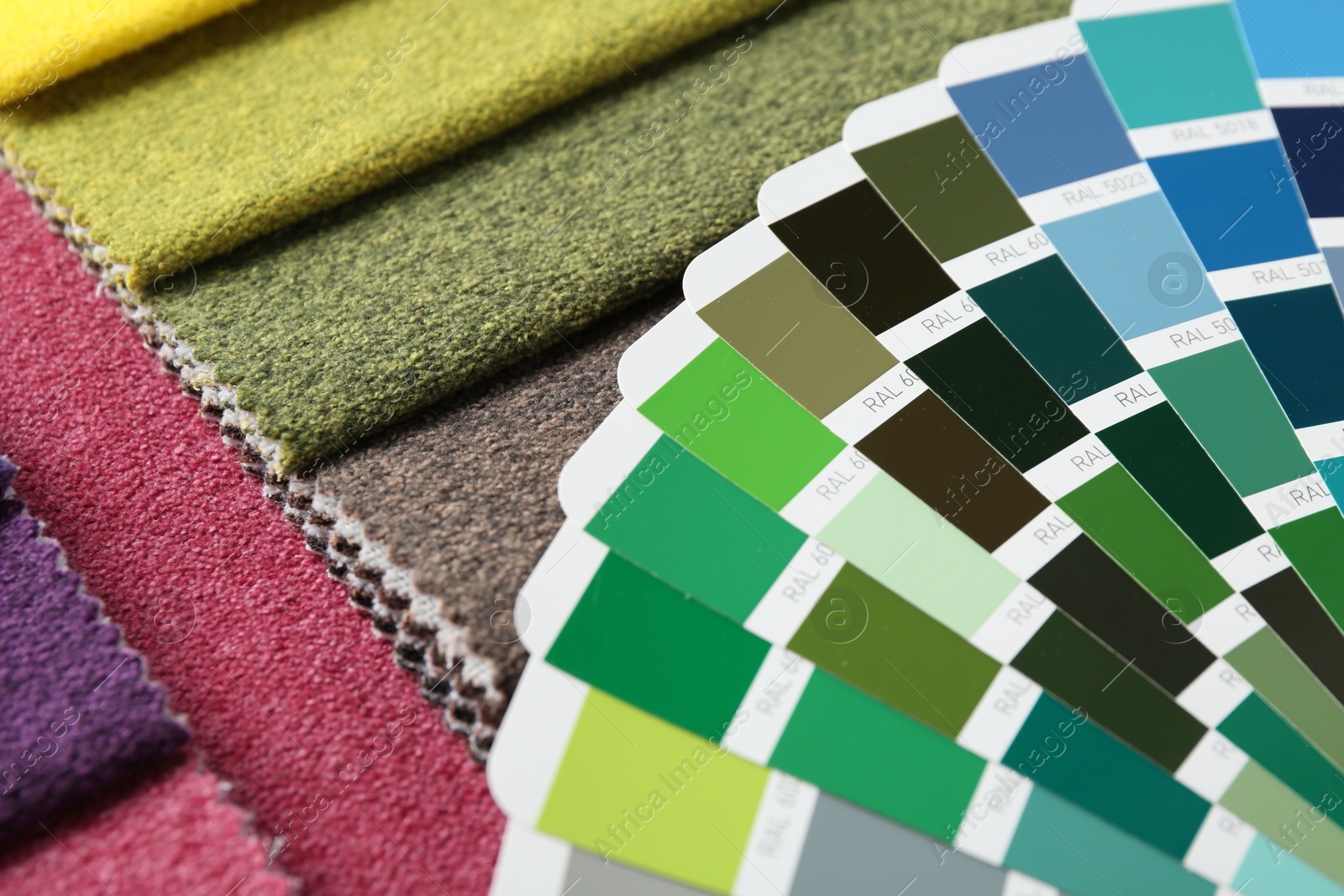 Photo of Samples of colorful fabrics and color palettes, closeup