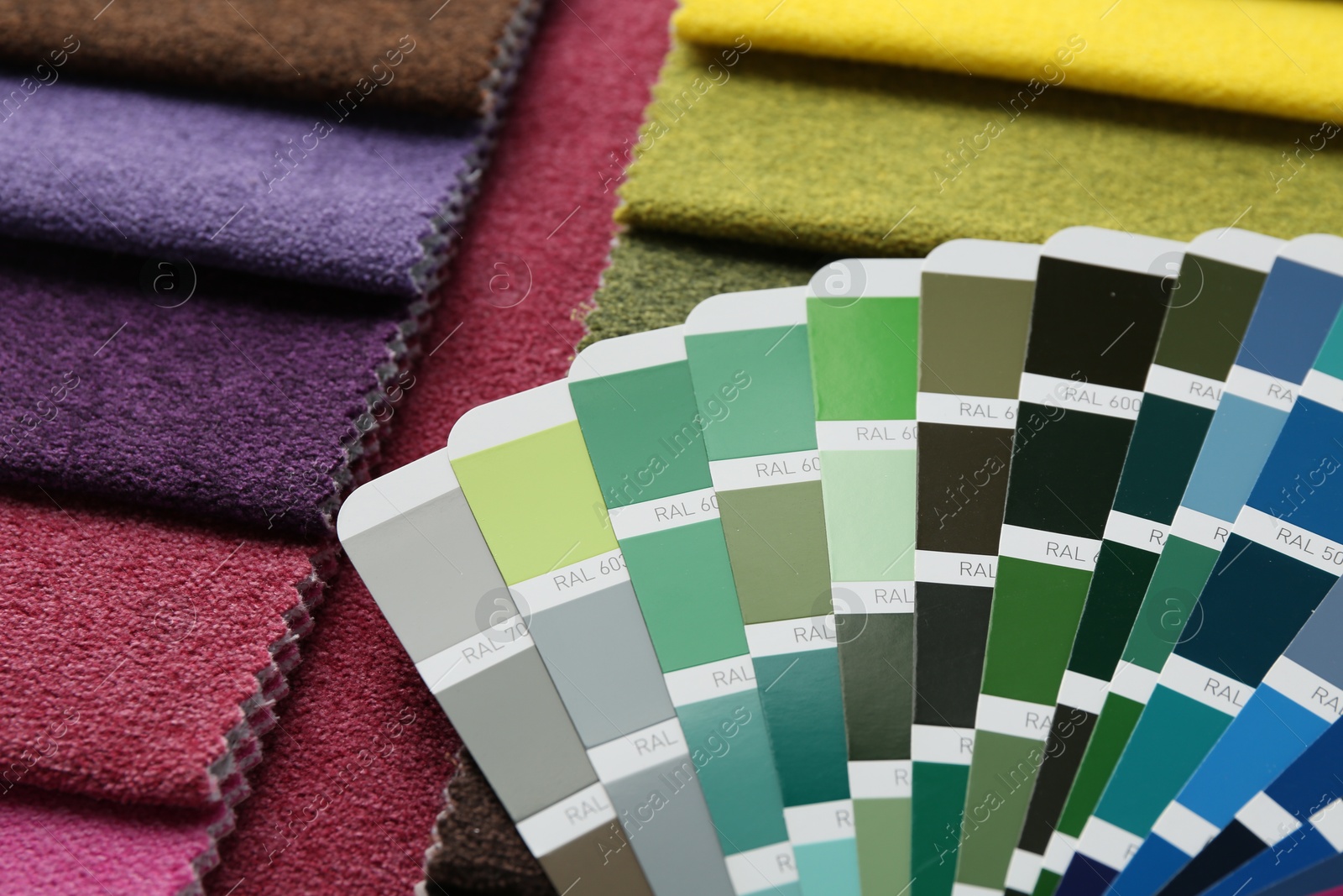 Photo of Samples of colorful fabrics and color palettes, closeup
