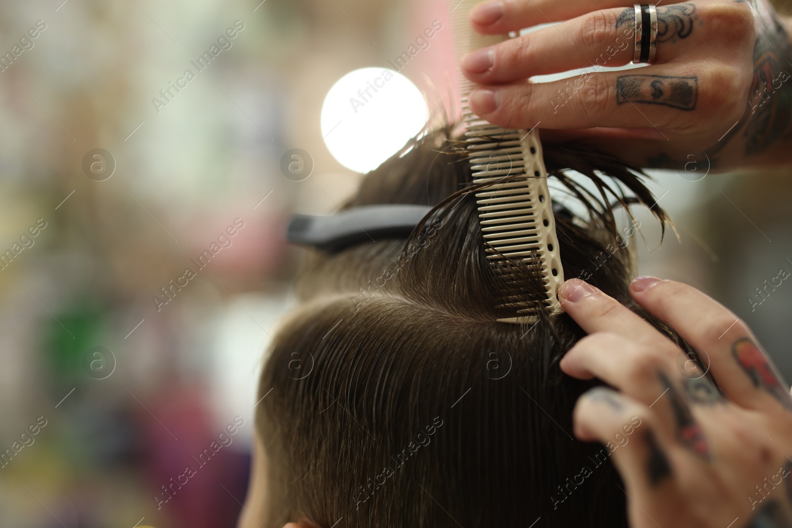 Professional barber working with client in barbershop, closeup. Space for text Photo of Professional barber working with client in barbershop, closeup. Space for text