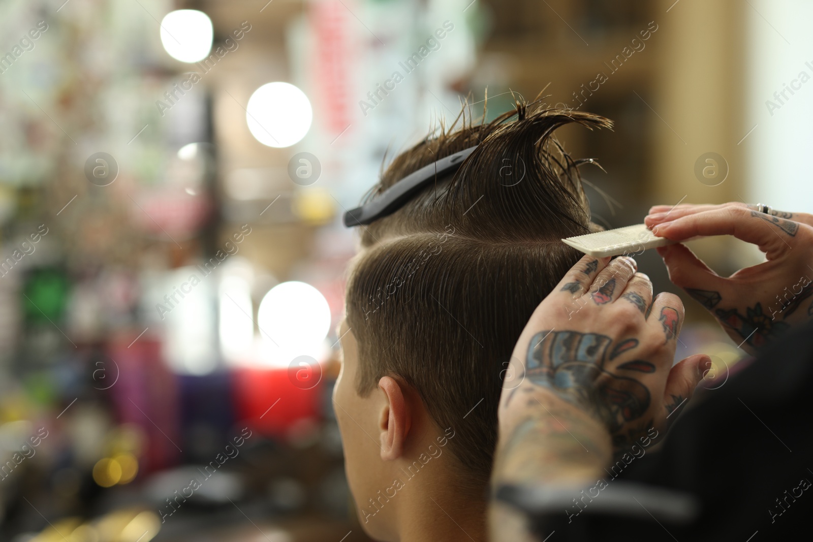 Professional barber working with client in barbershop, closeup. Space for text Photo of Professional barber working with client in barbershop, closeup. Space for text