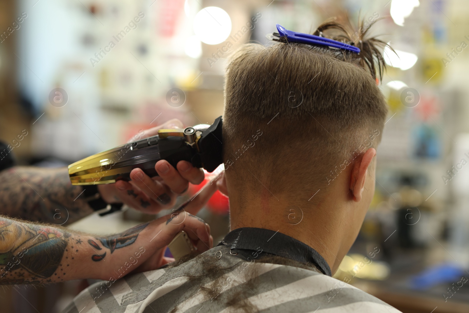 Professional barber making stylish haircut in barbershop, closeup Photo of Professional barber making stylish haircut in barbershop, closeup