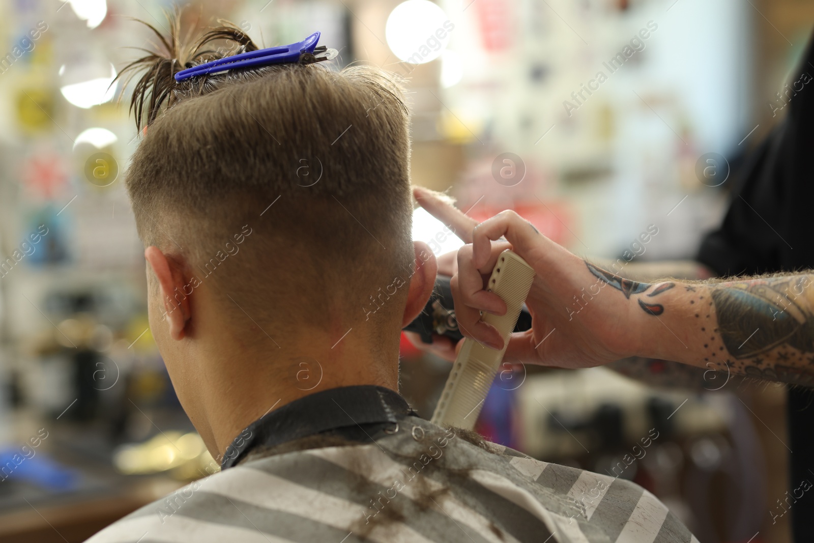 Professional barber making stylish haircut in barbershop, closeup Photo of Professional barber making stylish haircut in barbershop, closeup