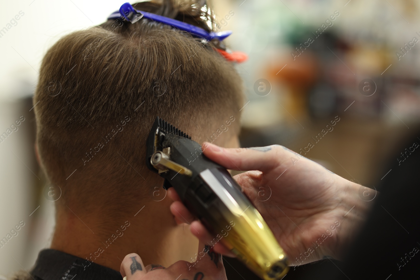 Professional barber making stylish haircut in barbershop, closeup Photo of Professional barber making stylish haircut in barbershop, closeup