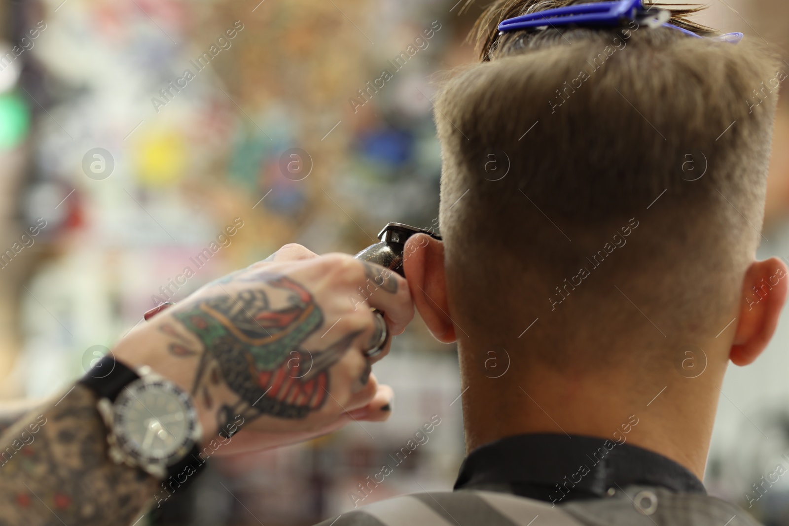 Professional barber making stylish haircut in barbershop, closeup Photo of Professional barber making stylish haircut in barbershop, closeup