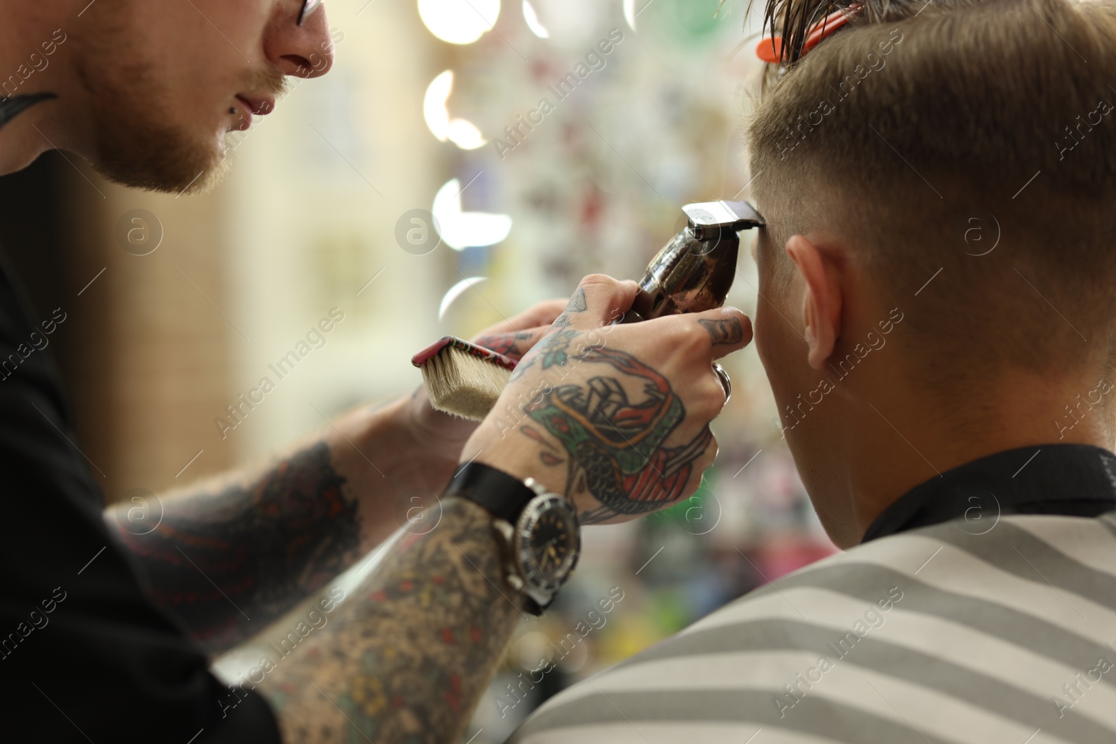 Professional barber making stylish haircut in barbershop, closeup Photo of Professional barber making stylish haircut in barbershop, closeup