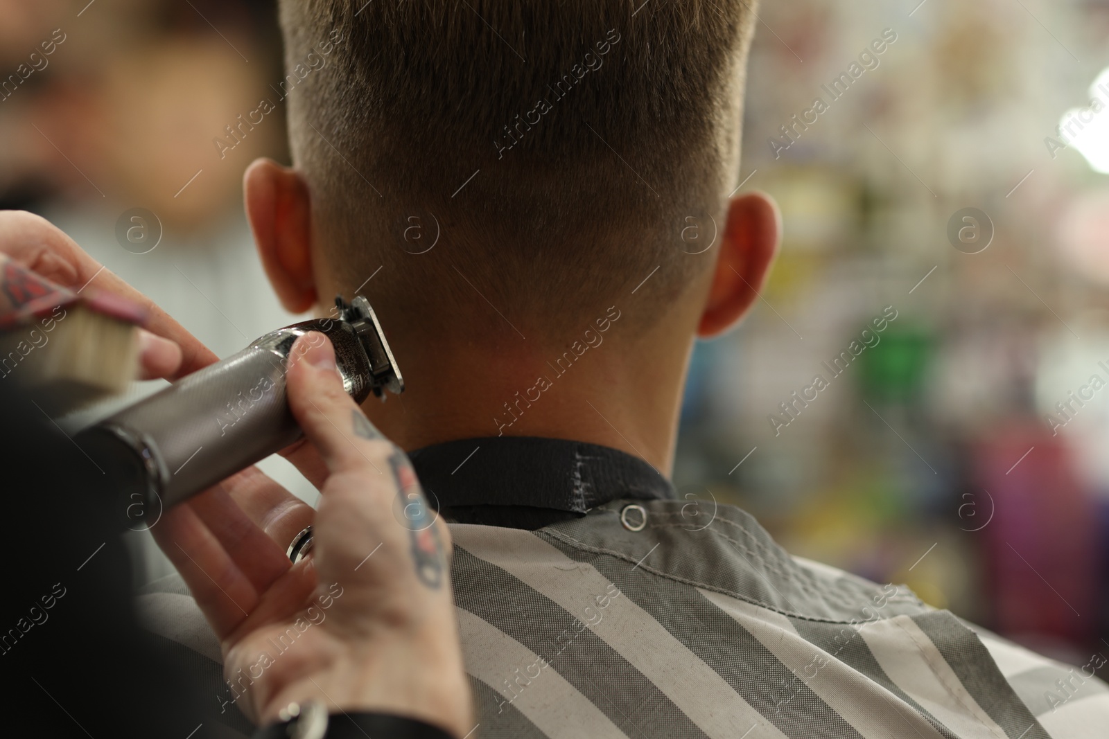 Professional barber making stylish haircut in barbershop, closeup Photo of Professional barber making stylish haircut in barbershop, closeup