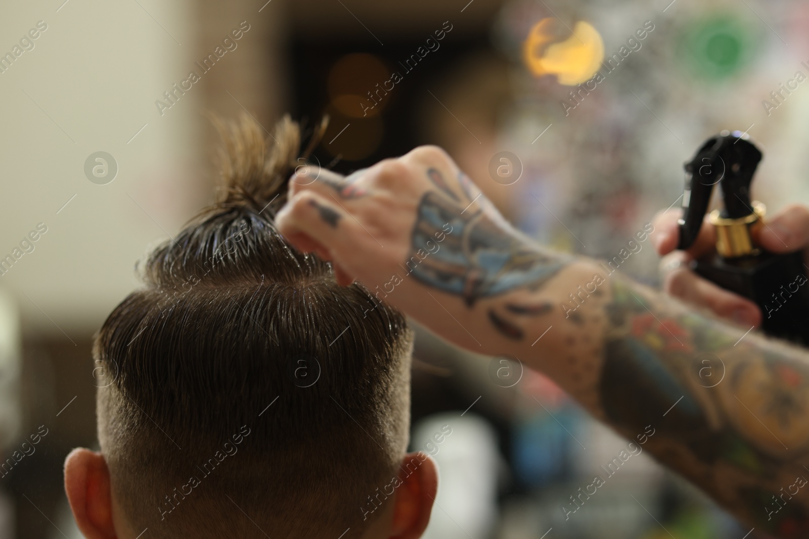 Professional barber making stylish haircut in barbershop, closeup Photo of Professional barber making stylish haircut in barbershop, closeup