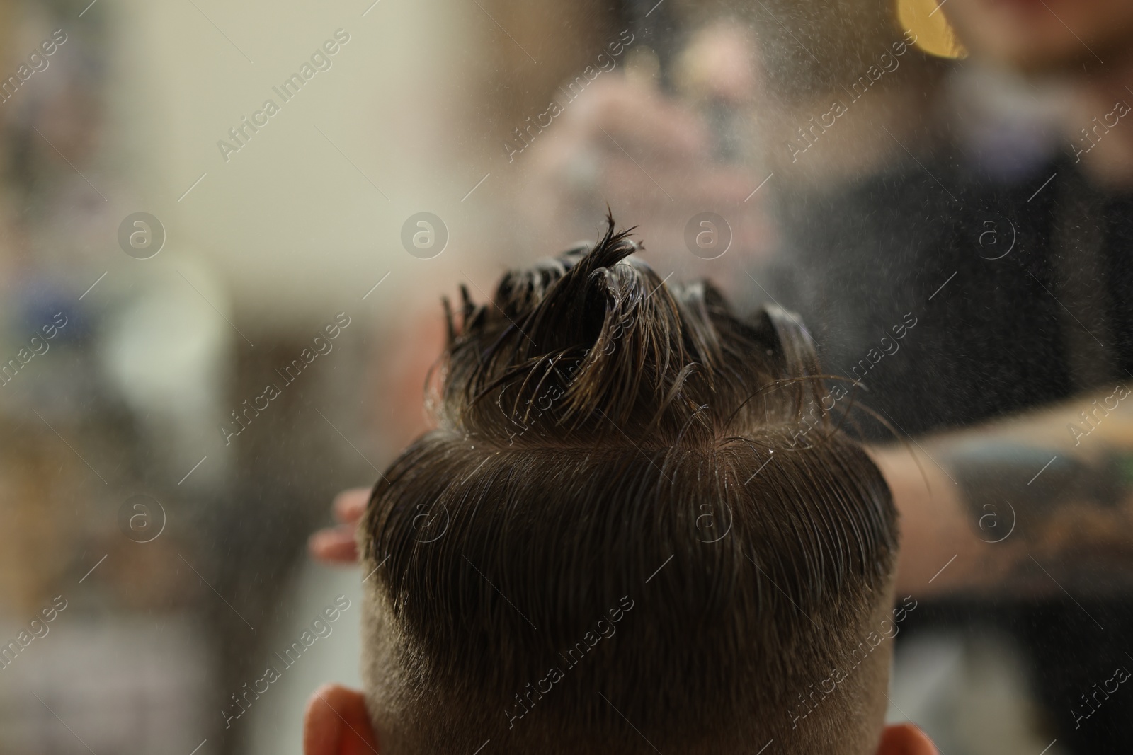Professional barber making stylish haircut in barbershop, closeup Photo of Professional barber making stylish haircut in barbershop, closeup