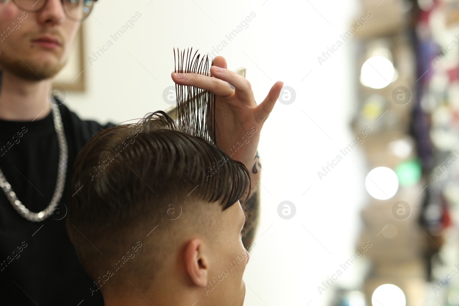 Professional barber making stylish haircut in barbershop, closeup. Space for text Photo of Professional barber making stylish haircut in barbershop, closeup. Space for text