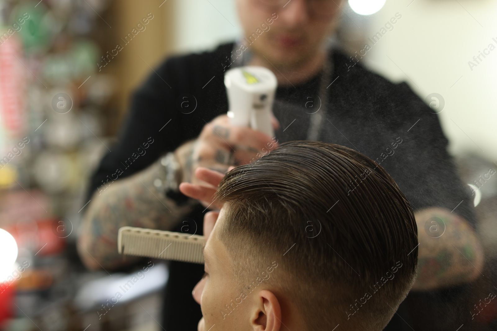 Professional barber making stylish haircut in barbershop, closeup Photo of Professional barber making stylish haircut in barbershop, closeup