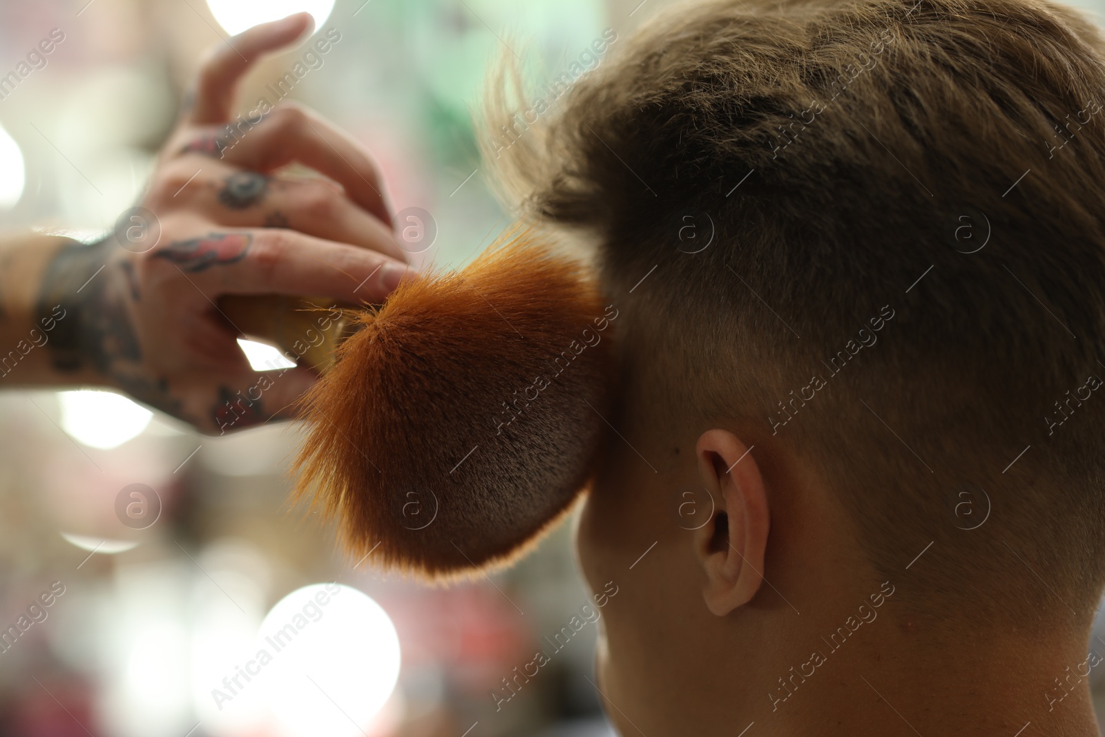 Professional barber working with client in barbershop, closeup Photo of Professional barber working with client in barbershop, closeup