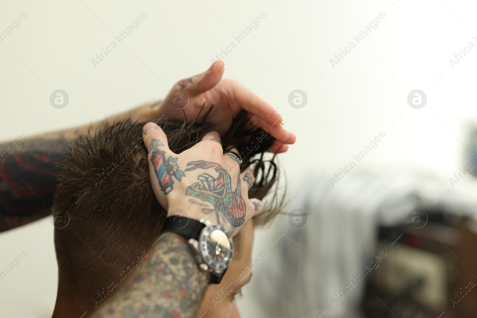 Professional barber working with client in barbershop, closeup. Space for text Photo of Professional barber working with client in barbershop, closeup. Space for text