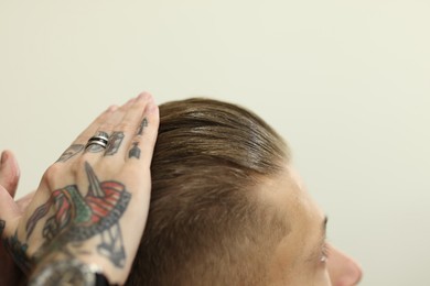 Photo of Professional barber working with client in barbershop, closeup