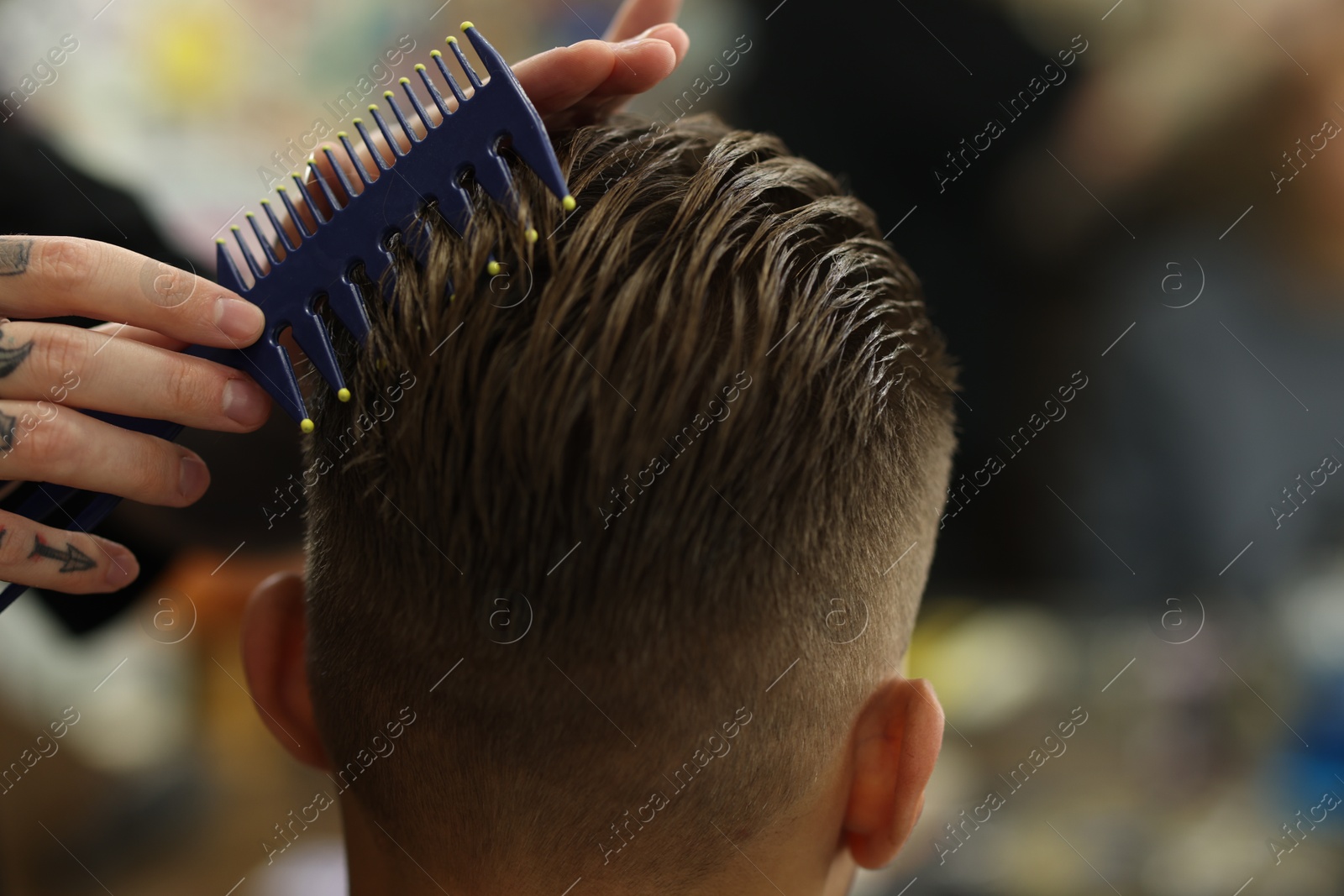 Professional barber making stylish haircut in barbershop, closeup Photo of Professional barber making stylish haircut in barbershop, closeup