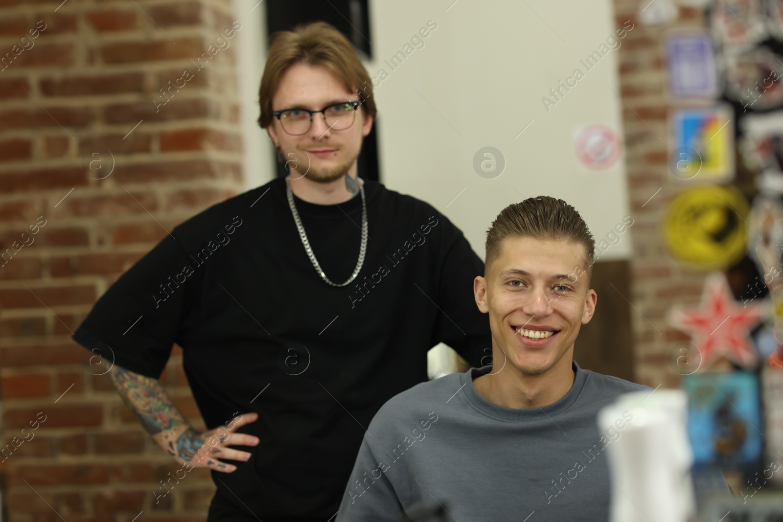 Professional barber working with client in barbershop Photo of Professional barber working with client in barbershop