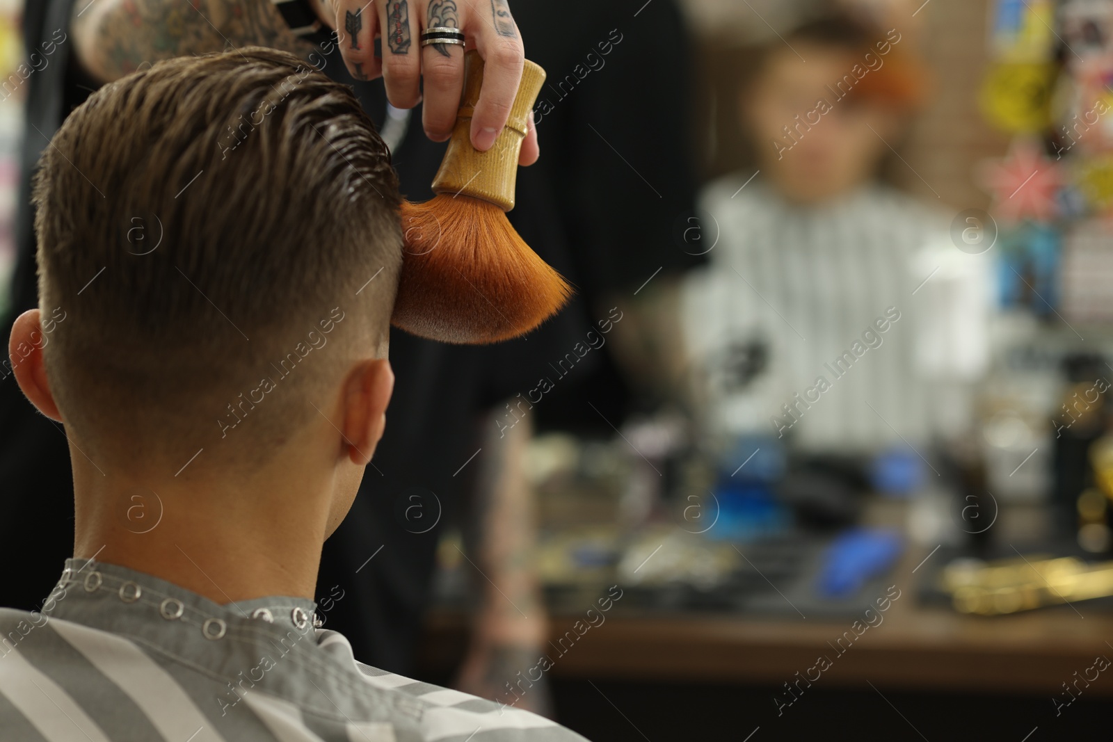 Professional barber working with client in barbershop, closeup. Space for text Photo of Professional barber working with client in barbershop, closeup. Space for text