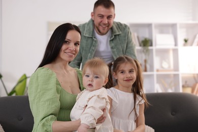 Photo of Happy parents and their kids together at home