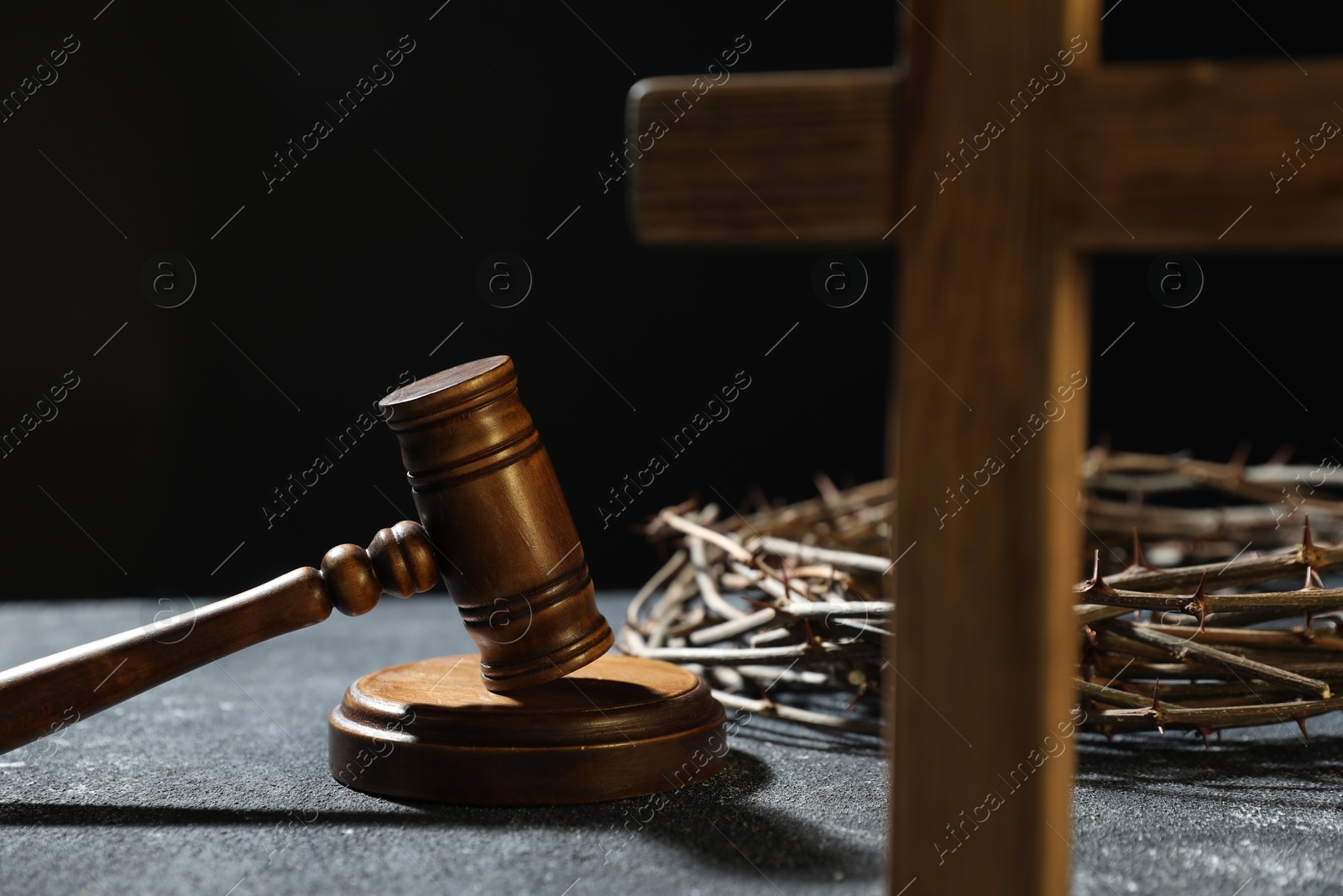 Crown of thorns, judge's gavel and wooden cross on dark textured background, closeup Photo of Crown of thorns, judge's gavel and wooden cross on dark textured background, closeup