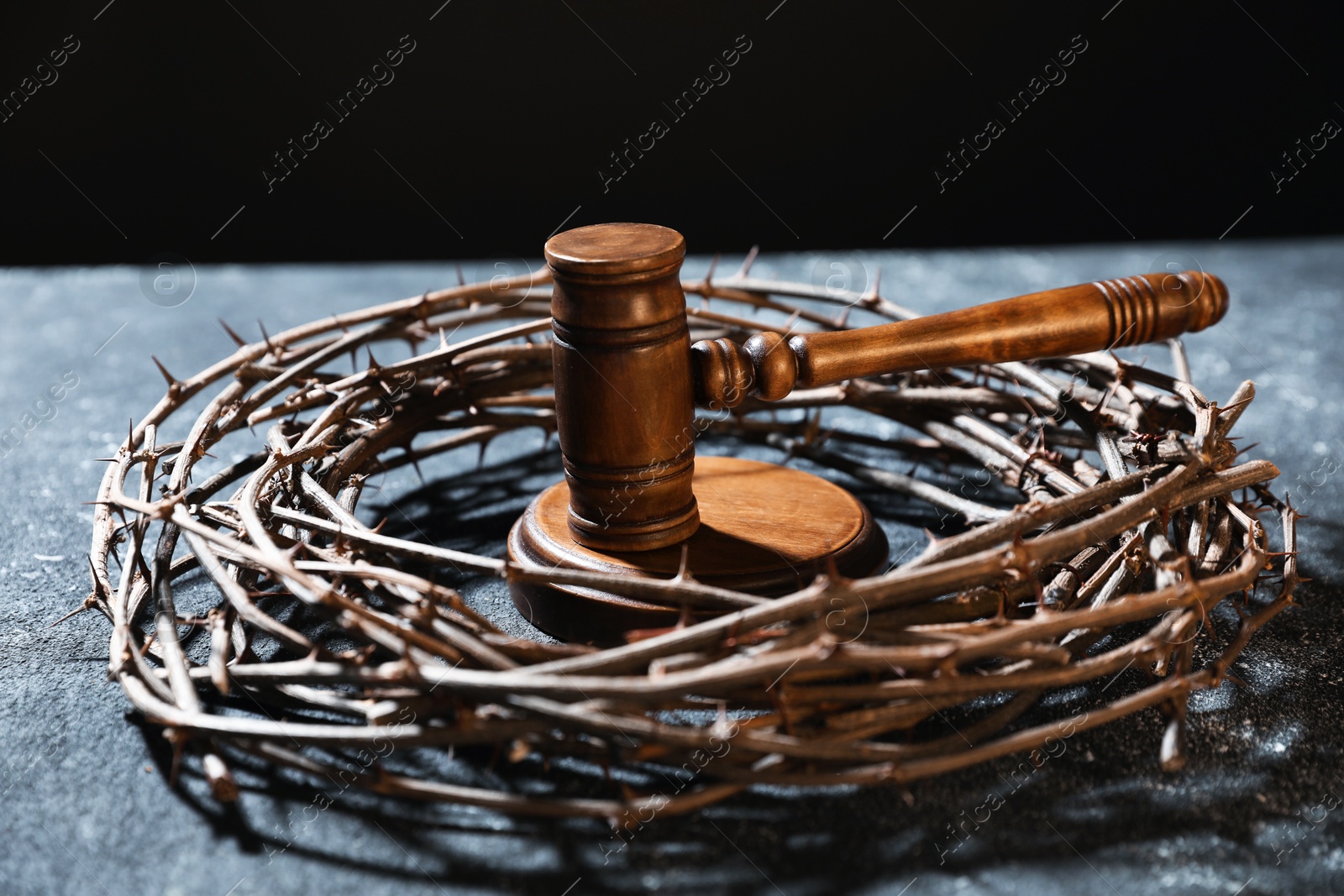 Crown of thorns and judge's gavel on dark textured background, closeup Photo of Crown of thorns and judge's gavel on dark textured background, closeup