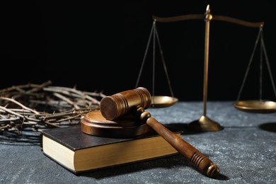 Photo of Crown of thorns, judge's gavel, Bible and scales on dark textured background