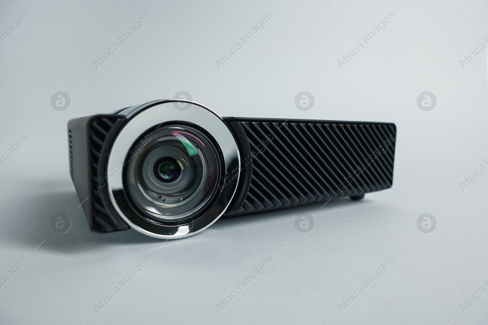 Modern video projector on light grey background, closeup Photo of Modern video projector on light grey background, closeup