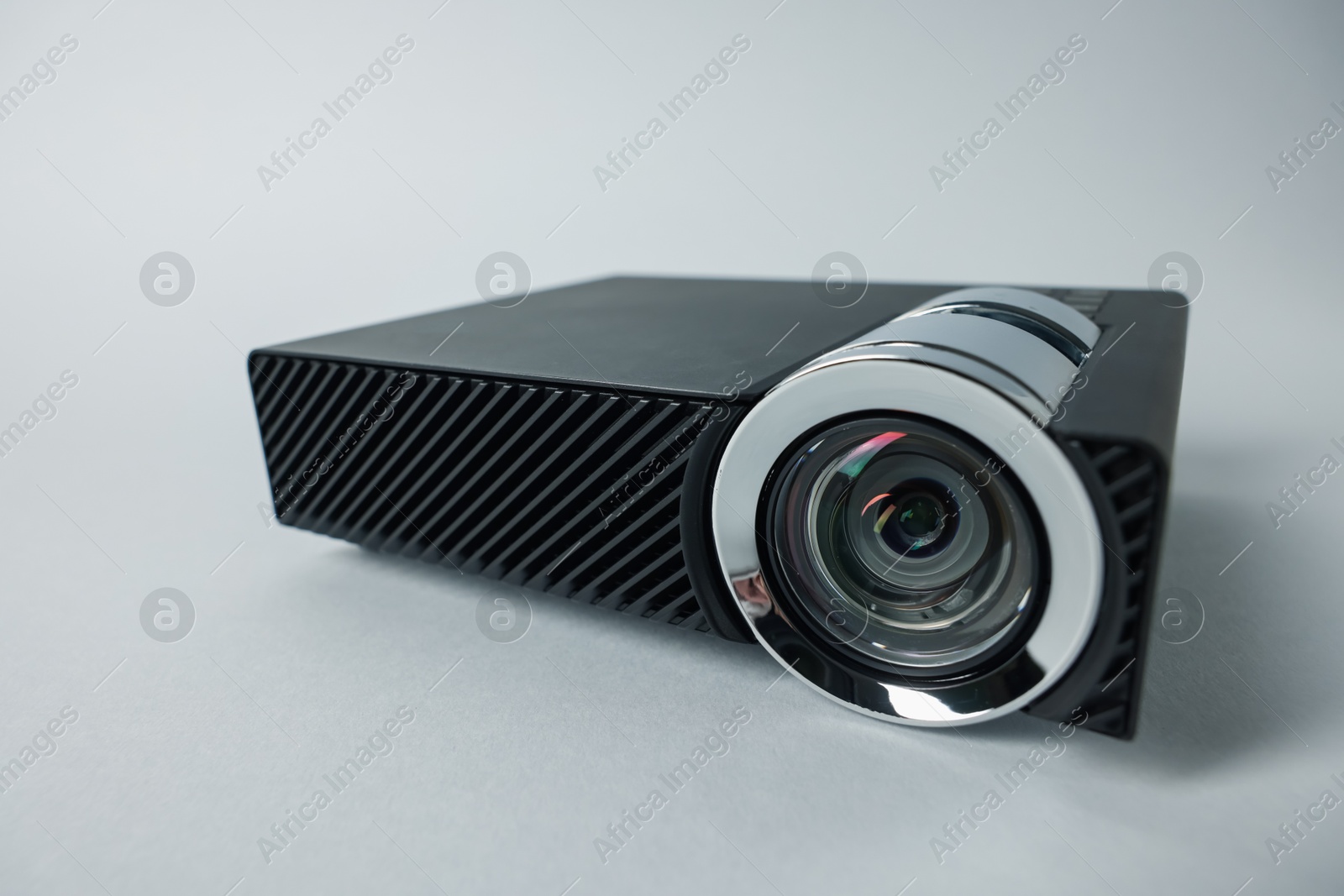 Modern video projector on light grey background, closeup Photo of Modern video projector on light grey background, closeup