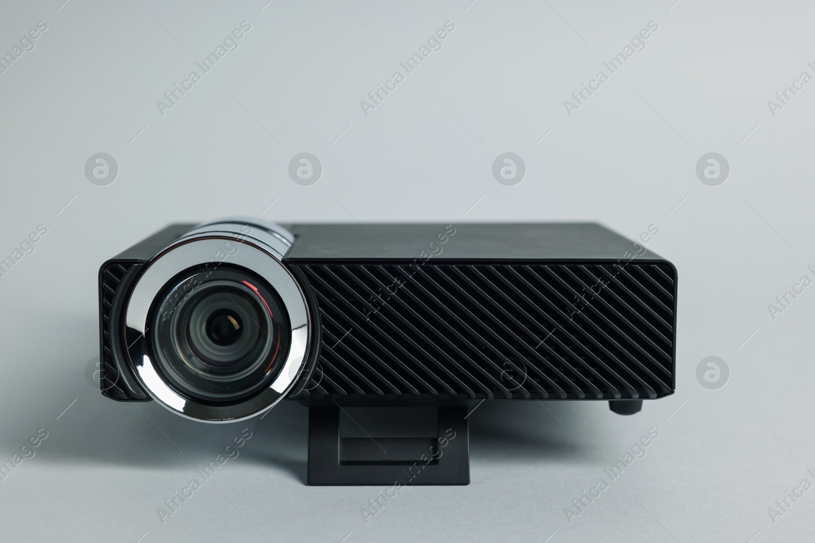Modern video projector on light grey background, closeup Photo of Modern video projector on light grey background, closeup