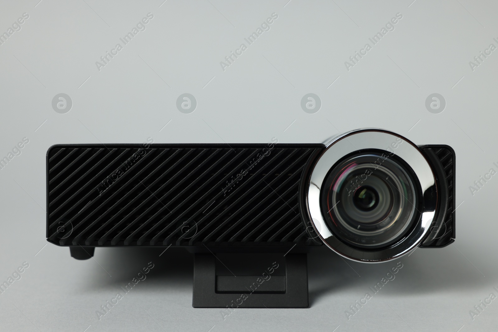 Modern video projector on light grey background, closeup Photo of Modern video projector on light grey background, closeup