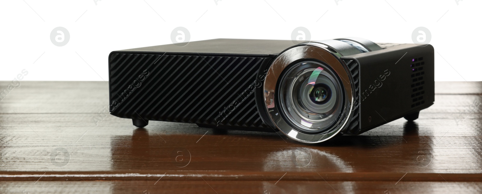 Modern video projector on wooden table against white background Photo of Modern video projector on wooden table against white background