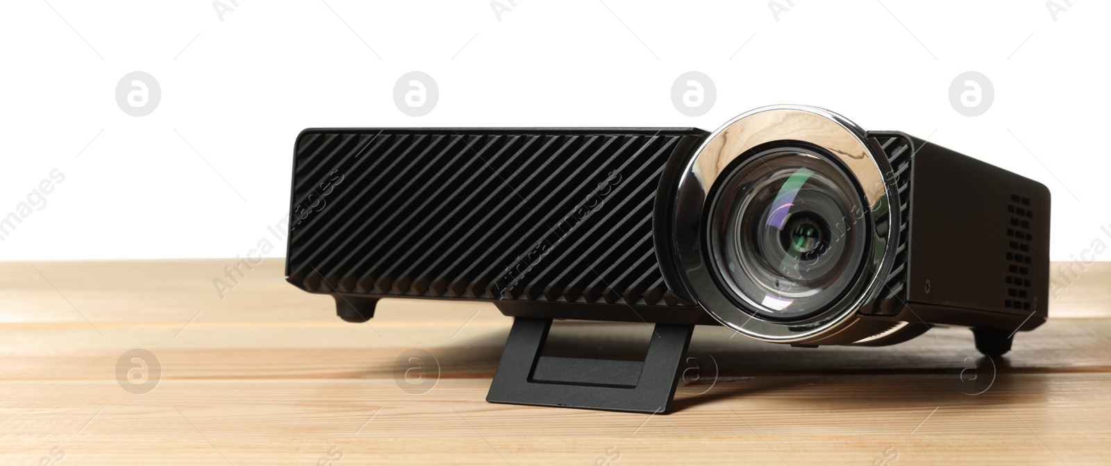 Modern video projector on wooden table against white background Photo of Modern video projector on wooden table against white background