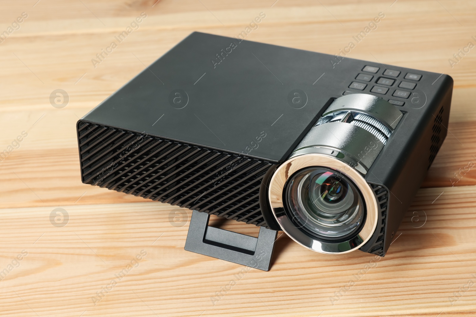Modern video projector on wooden table, closeup Photo of Modern video projector on wooden table, closeup