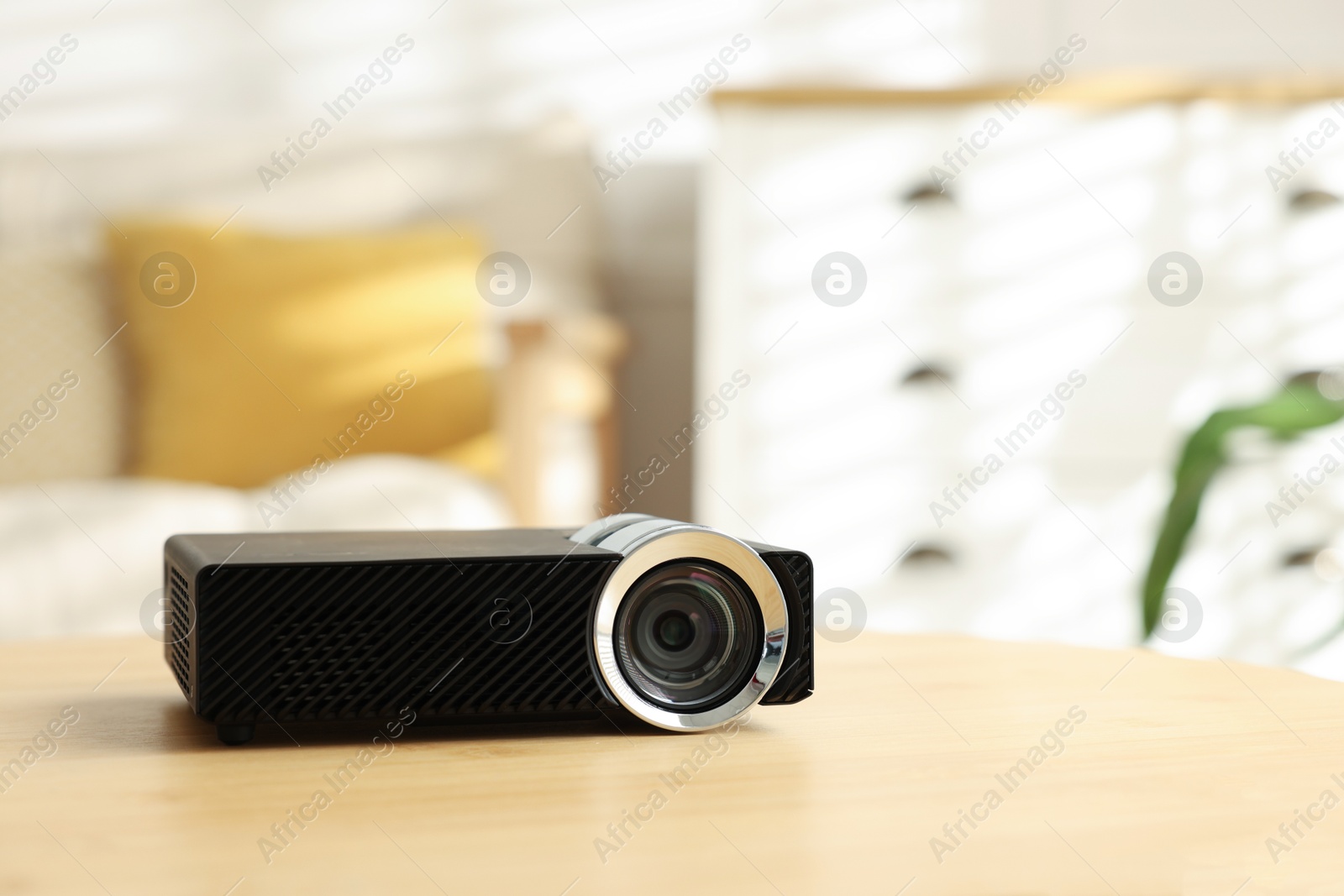 Modern video projector on wooden table indoors. Space for text Photo of Modern video projector on wooden table indoors. Space for text