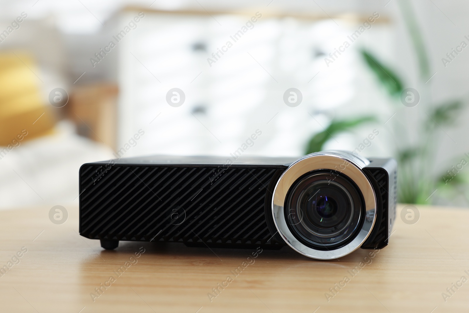 Modern video projector on wooden table indoors, closeup Photo of Modern video projector on wooden table indoors, closeup