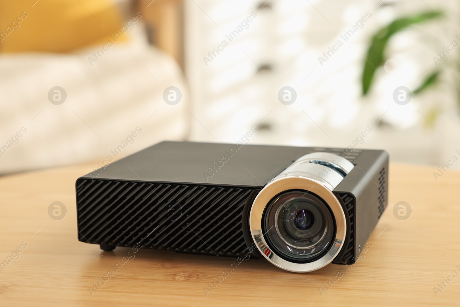 Modern video projector on wooden table indoors, closeup Photo of Modern video projector on wooden table indoors, closeup