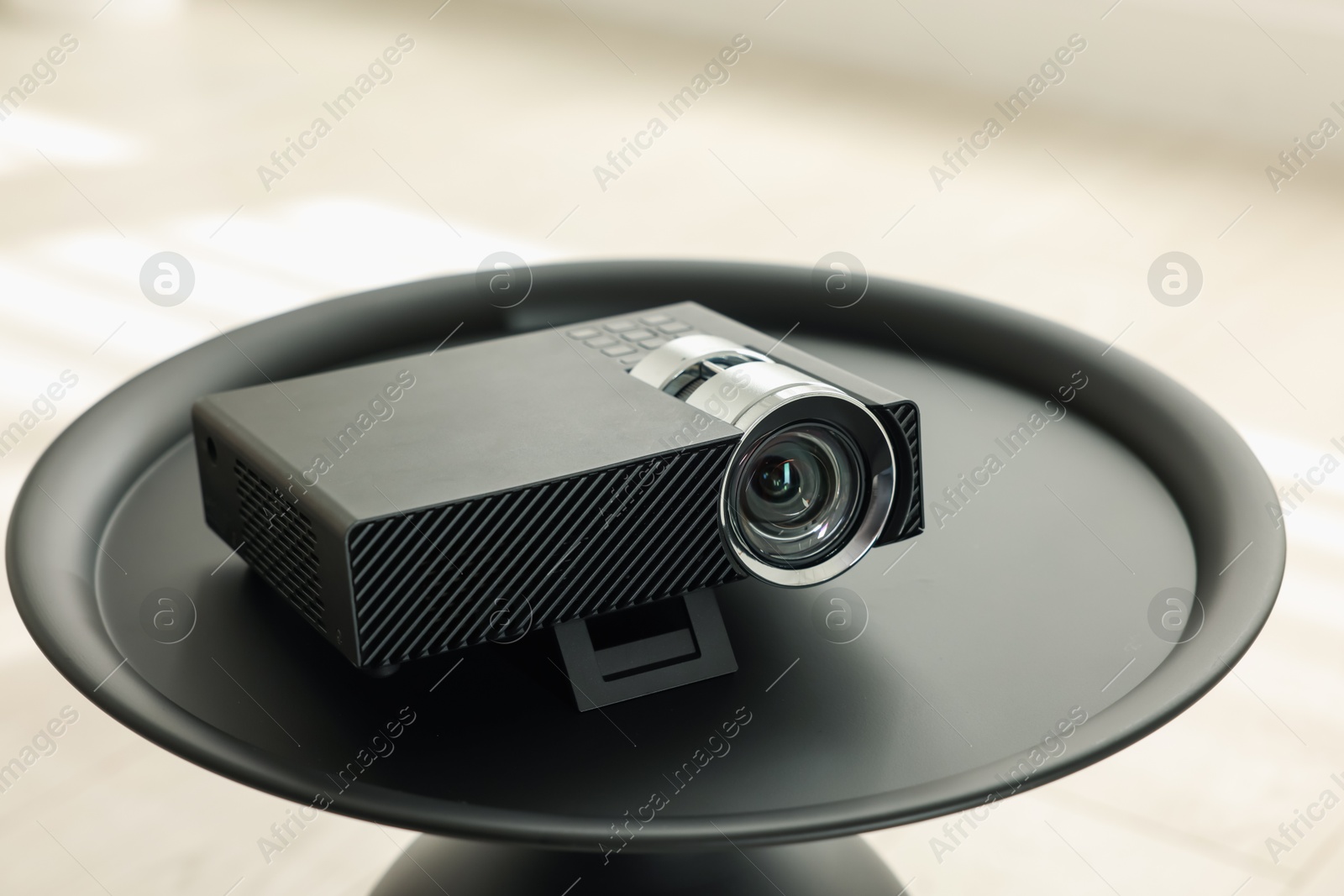 Modern video projector on black table indoors Photo of Modern video projector on black table indoors