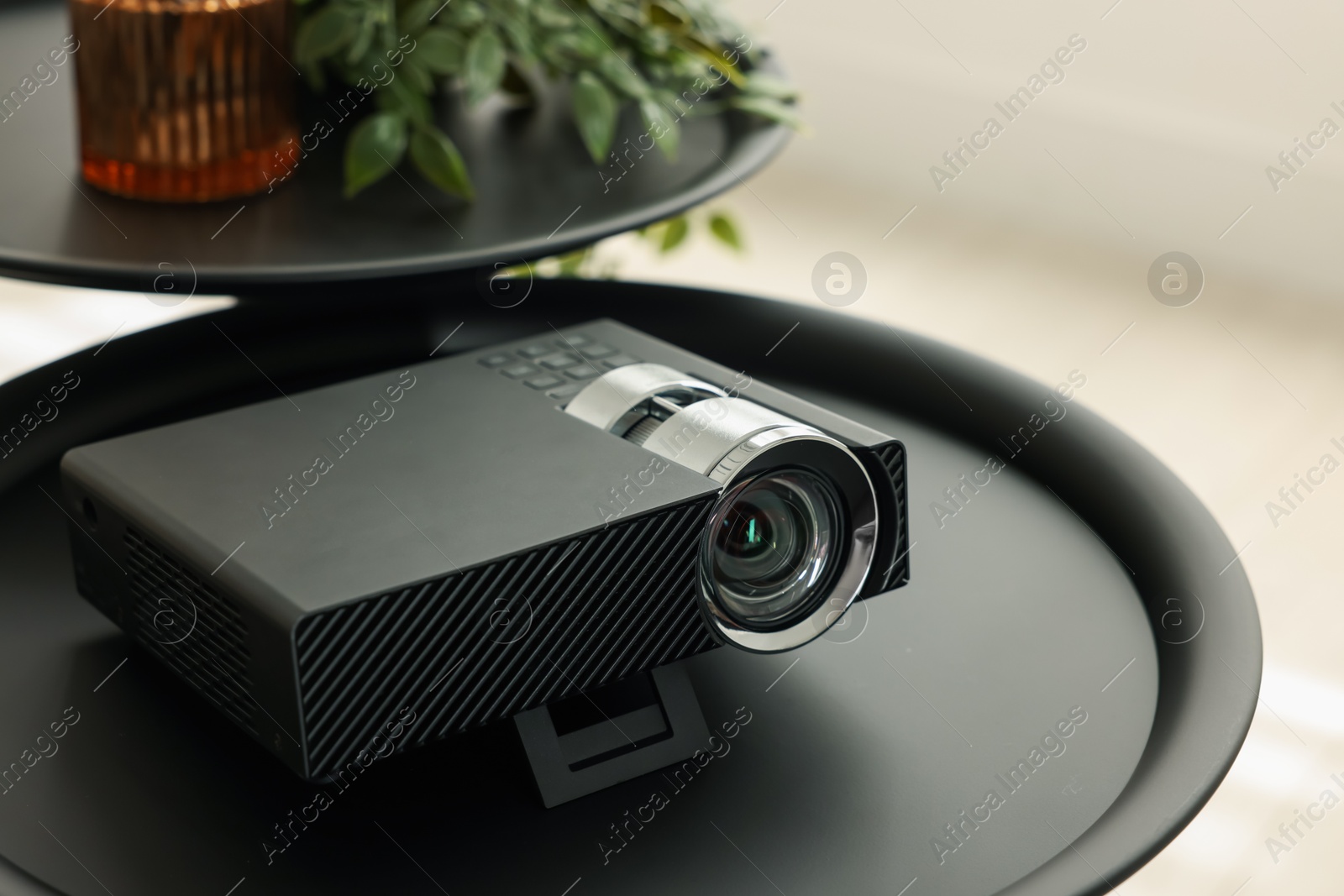 Modern video projector on black table indoors Photo of Modern video projector on black table indoors