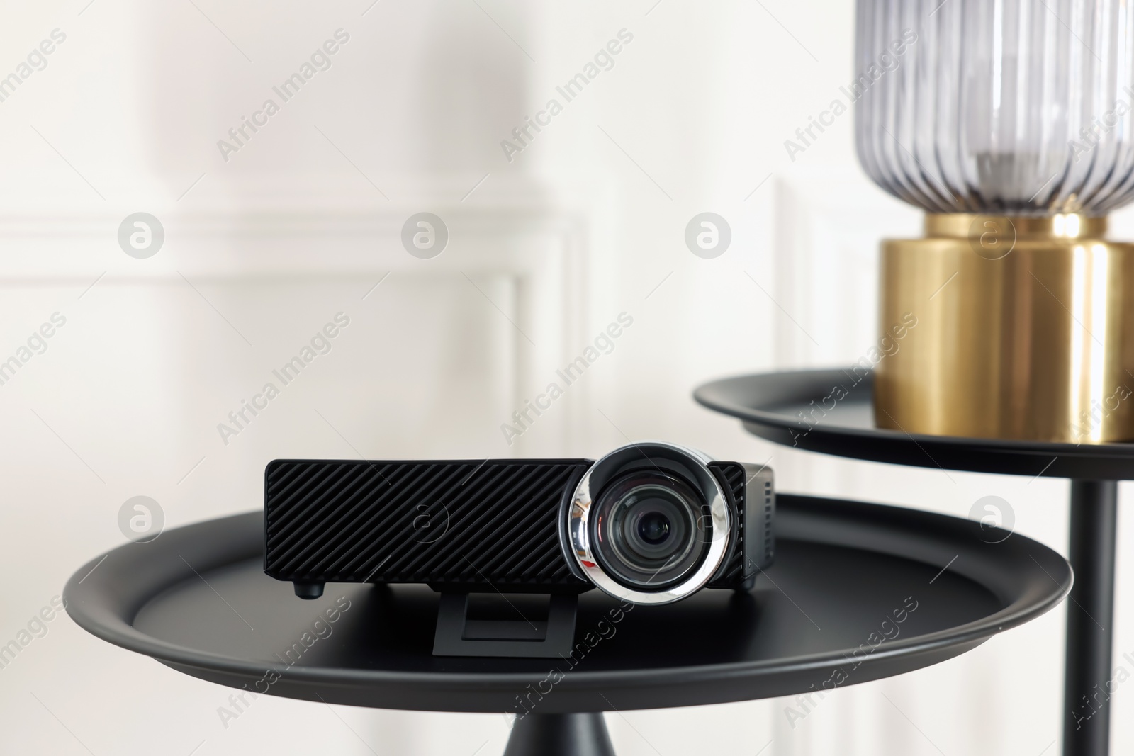 Modern video projector on black table indoors Photo of Modern video projector on black table indoors