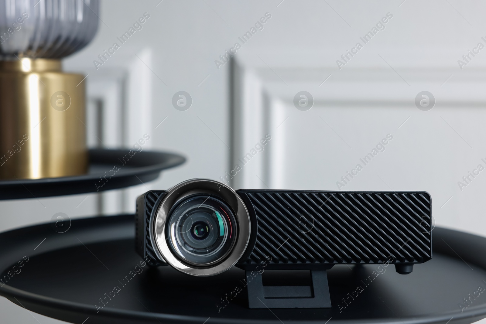 Modern video projector on black table indoors Photo of Modern video projector on black table indoors