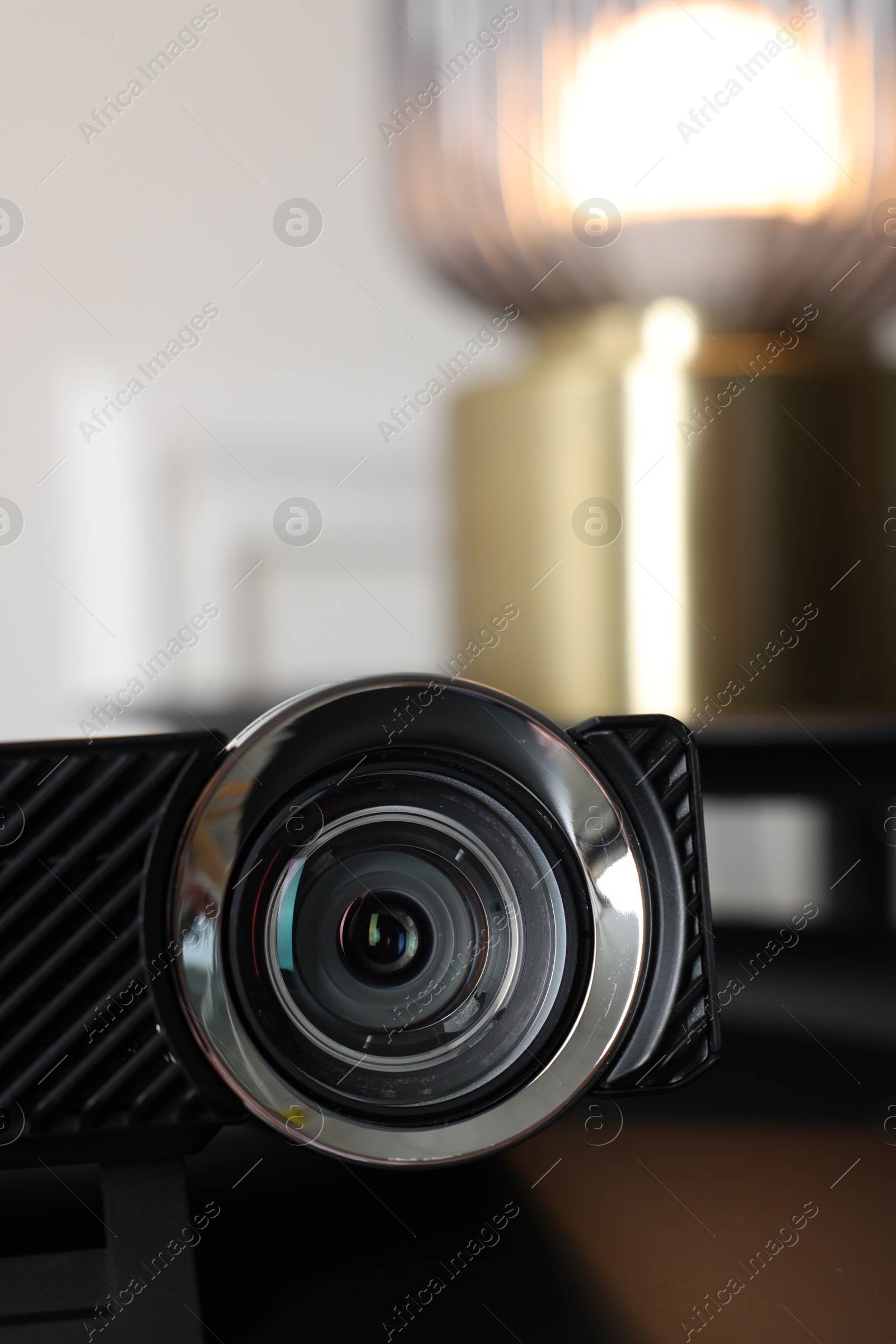 Modern video projector on black table indoors, closeup Photo of Modern video projector on black table indoors, closeup
