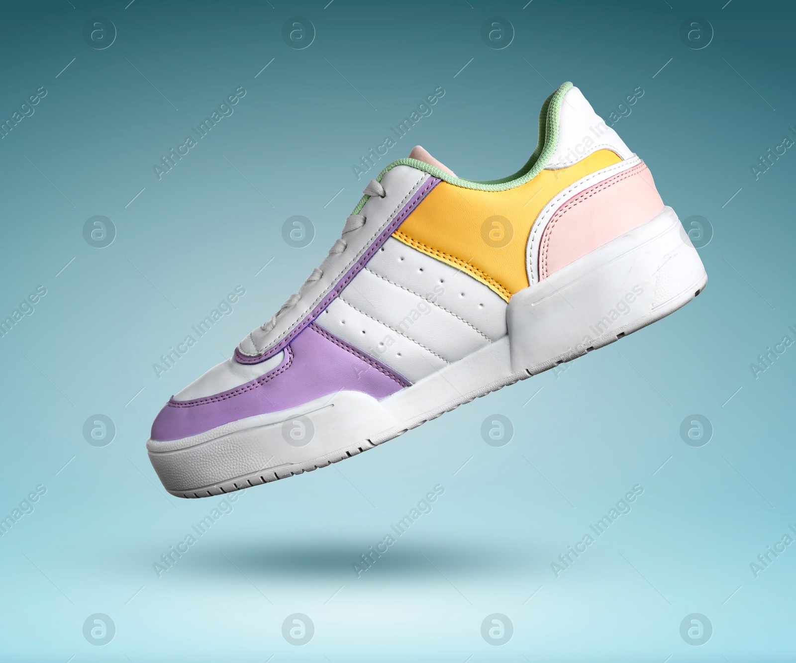 Stylish sneaker in air on teal gradient background Image of Stylish sneaker in air on teal gradient background